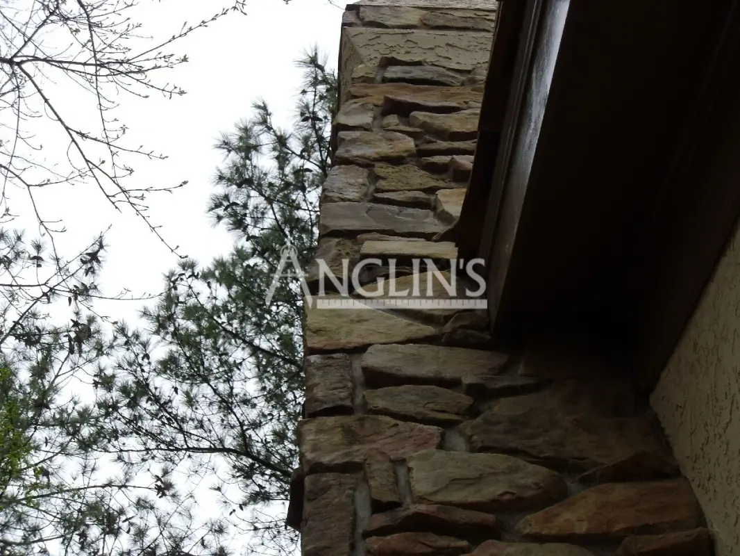 a house with a chimney that is leaning