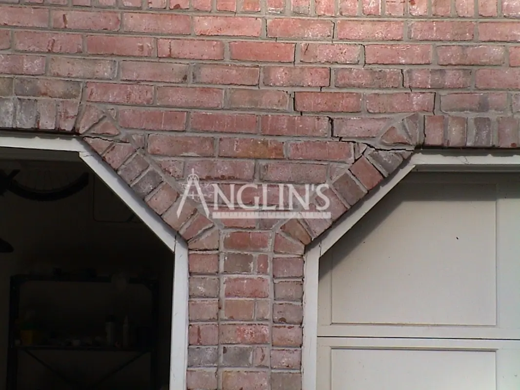 crack in a brick wall over a garage door