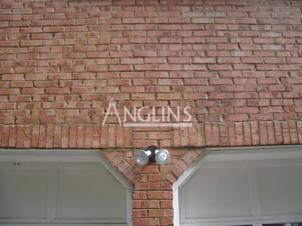 wall over the garage door after mansonry repair done by anglin's team