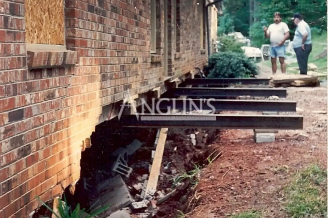 building standing on steel support beams because the basement wall fell and it required repair
